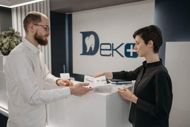 hereth insurance consulting - is dental insurance worth it - Woman Receiving Documents