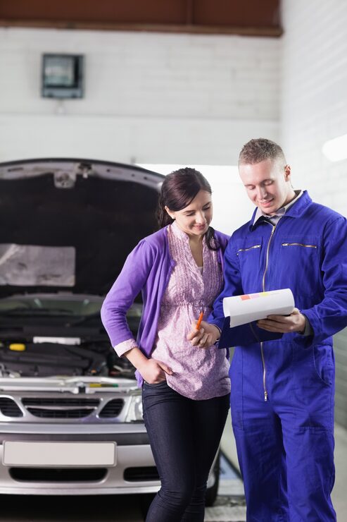 hereth insurance consulting - garage liability insurance - mechanic showing a clipboard to a customer
