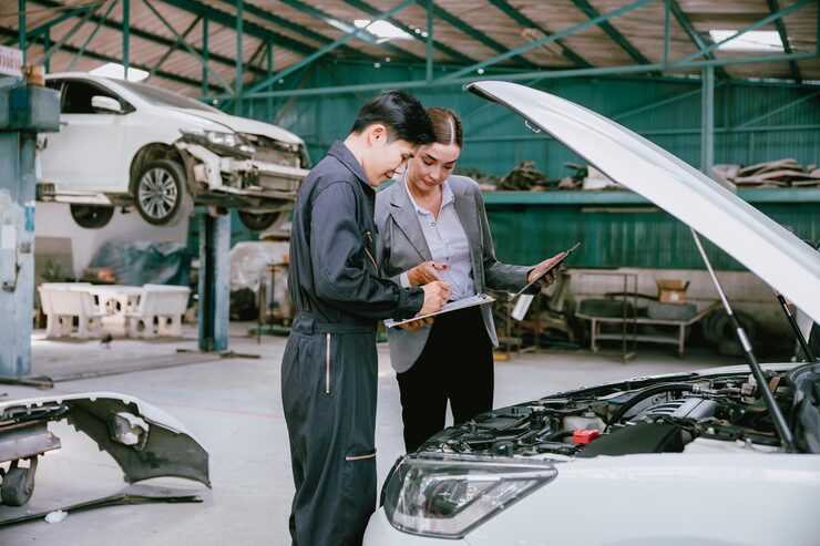 hereth insurance consulting - auto repair shop insurance - shop owner and team reviewing a repair cost estimate